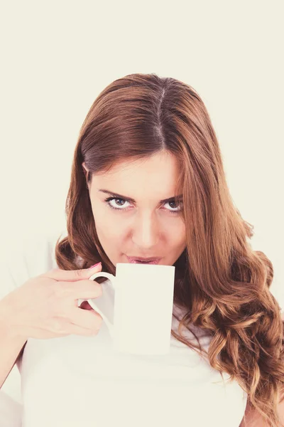 Closeup portrait of a happy young beautiful woman with a white c — Stock Photo, Image