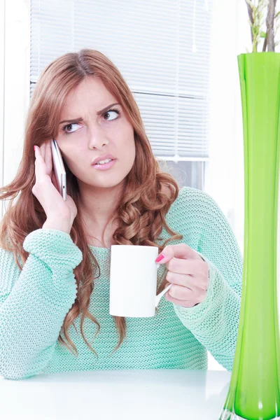 Worried woman receiving bad news over phone — Stock Photo, Image