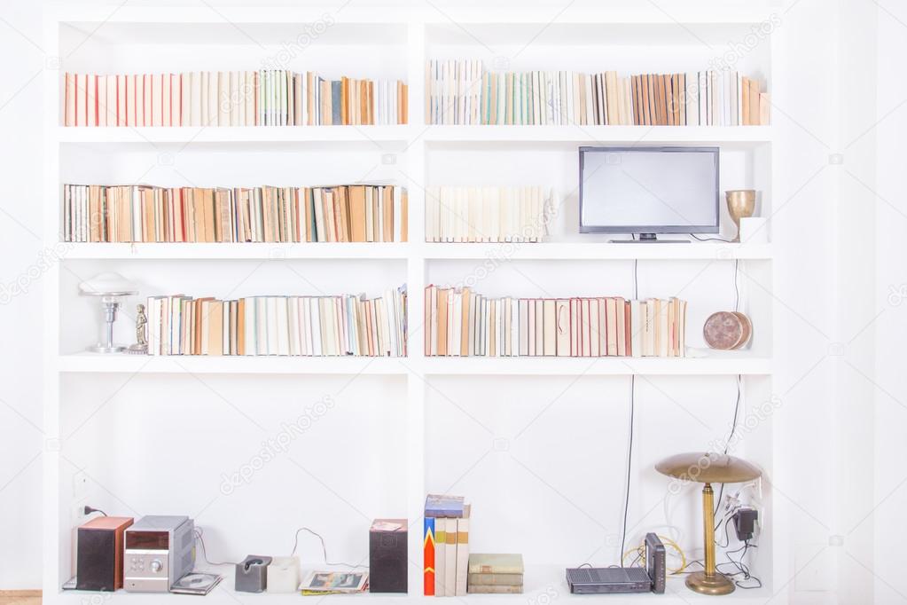 white living room with modern wooden bookshelf