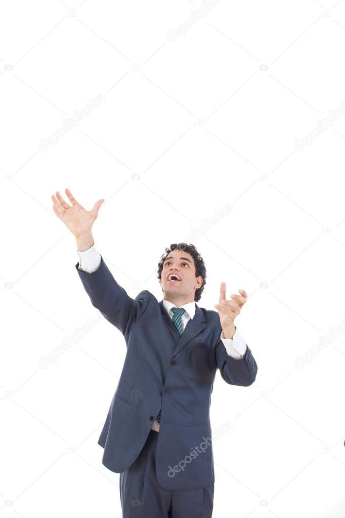 business man reaching to grab something from above his head