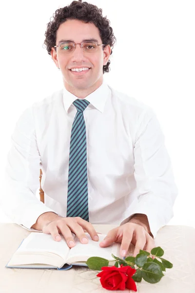 Student wearing glasses and tie relaxing with book and rose — Stock Photo, Image