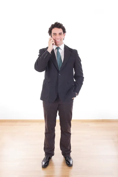 Exitoso hombre de negocios en traje hablando con el teléfono móvil celular — Foto de Stock