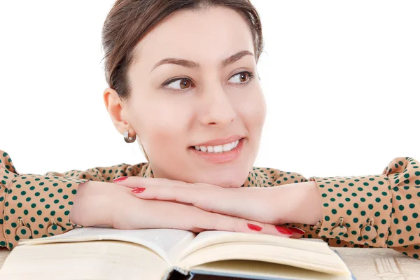 Beautiful woman leaning on book looking aside — Stock Photo, Image