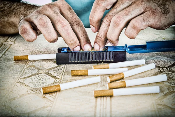 Manos de hombre haciendo cigarrillos — Foto de Stock