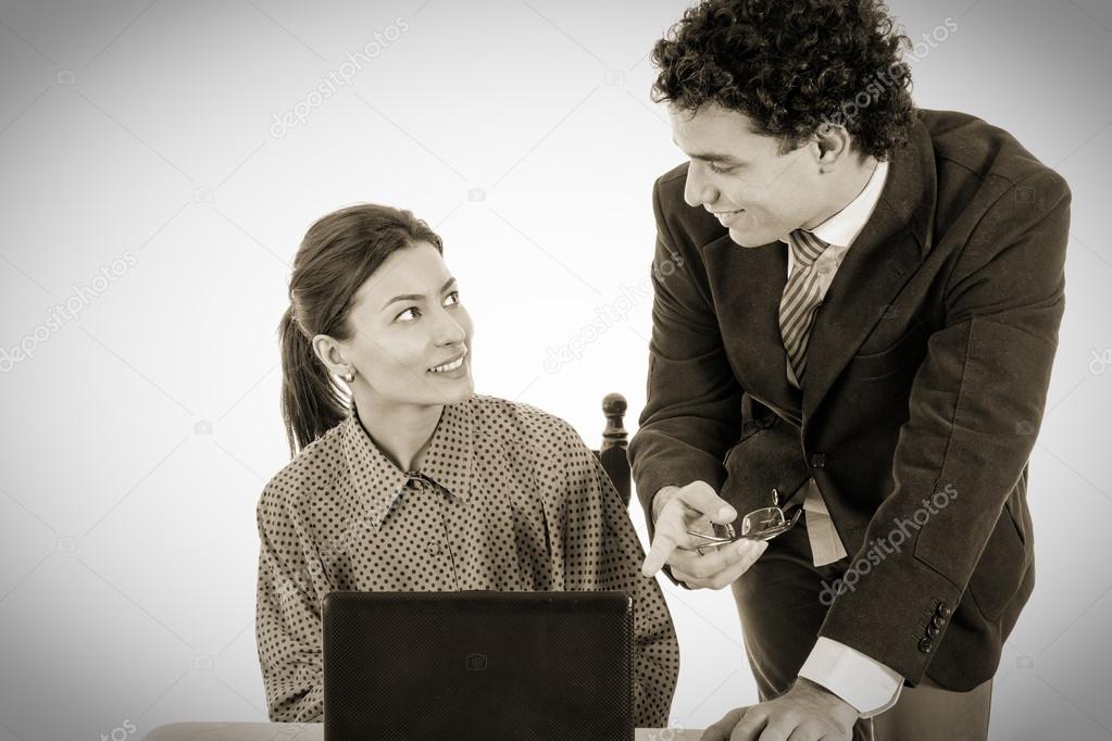 happy Boss and smiling secretary working together on laptop