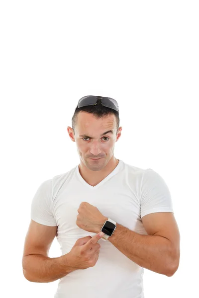 Muž v bílé tričko, ukazující prstem na hodiny do fotoaparátu — Stock fotografie