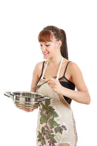 Young woman in housewife with pot and fork — Stock Photo, Image