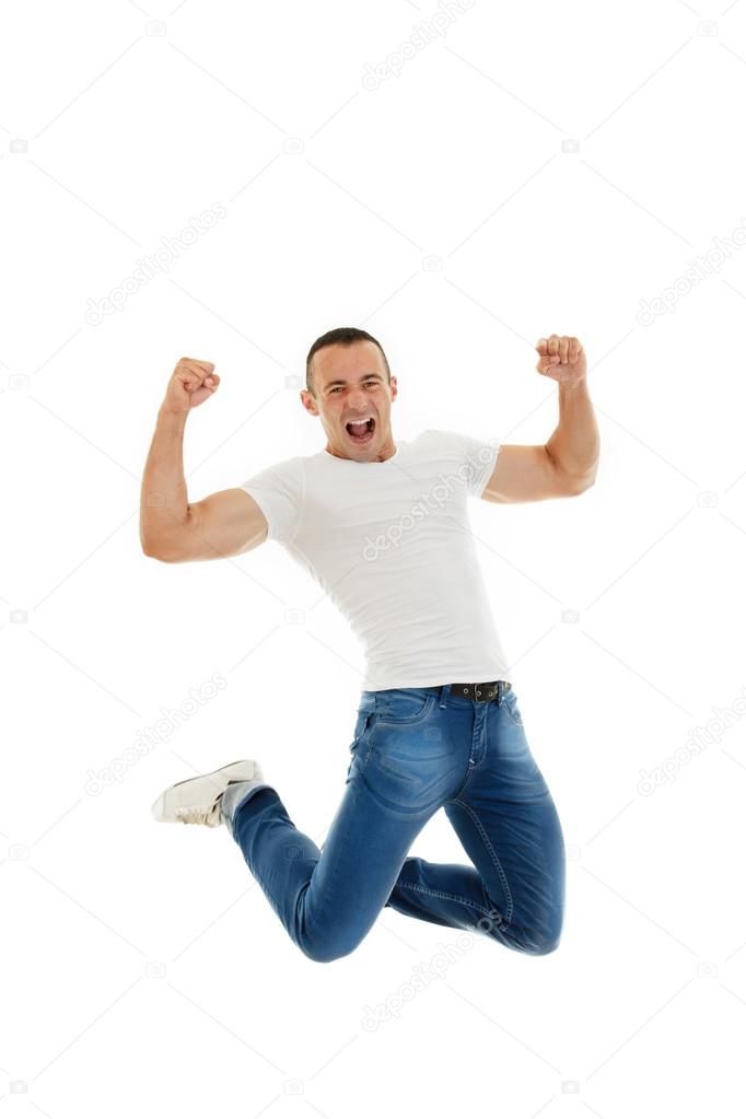 Excited Casual Young Caucasian Man Clenching His Fists and jumpi