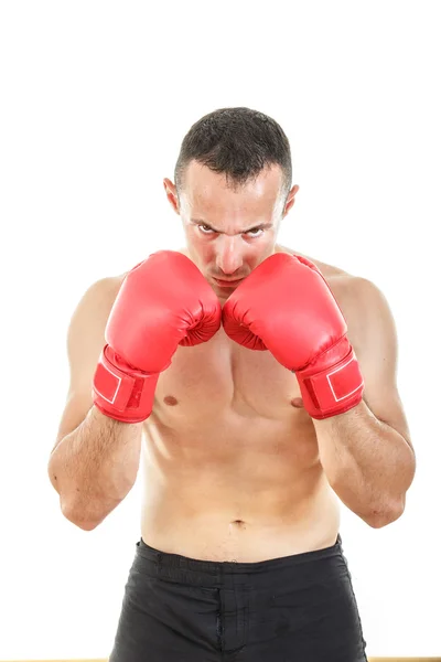 Serious muscular man with connected red boxing gloves near his f Stock Image