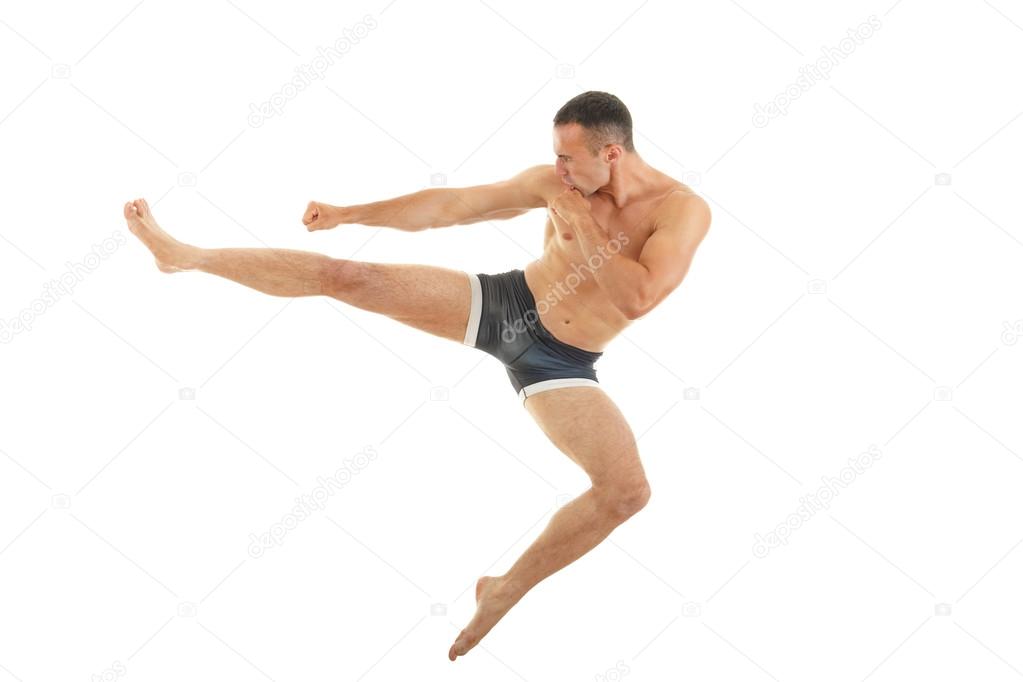 Excellent fight pose of intense man boxer with a kick