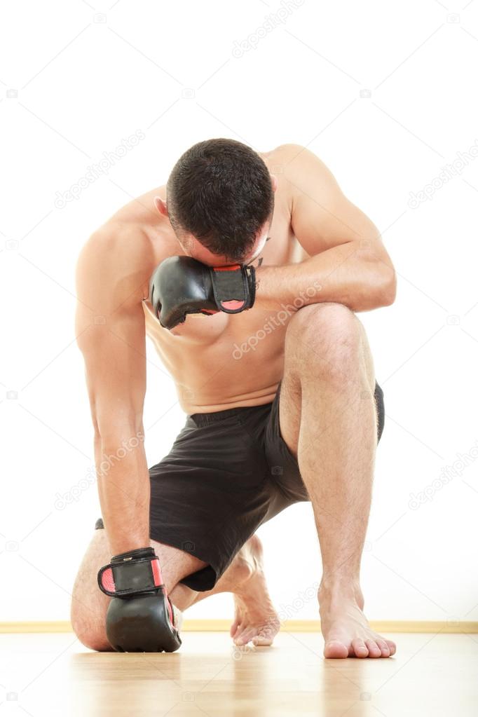 concentrated martial fighter with fight gloves pray for victory