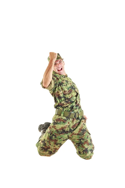 Handsome soldier in green camouflage uniform and hat jumping — Stock Photo, Image