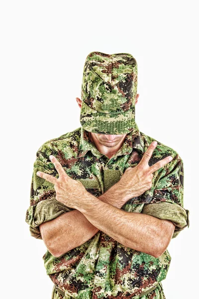 Soldier standing with sign of peace with cross arms — Stock Photo, Image