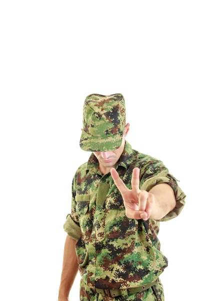 Soldier uniform and hat standing and showing the peace sign with — Stock Photo, Image