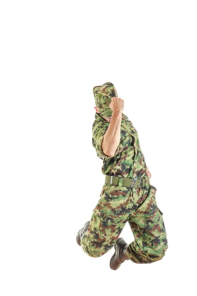 Soldier with hidden face in green camouflage uniform and hat jum — Stock Photo, Image