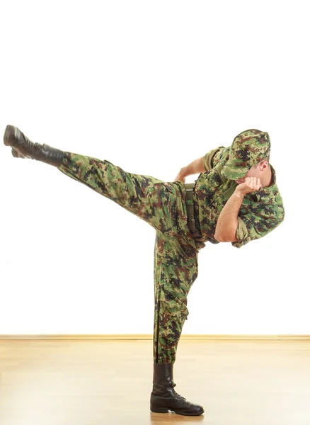 Unknown soldier with hidden face in green camouflage uniform — Stock Photo, Image