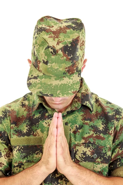 War soldier praying in military camouflage uniform with head bow — Stock Photo, Image