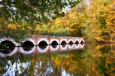 Sonbaharda nehrin üzerinde eski bir taş köprü. Ukrayna