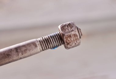 Fındıklı, bulanık arkaplanı olan bir cıvata üzerindeki mavi iplik kilidi