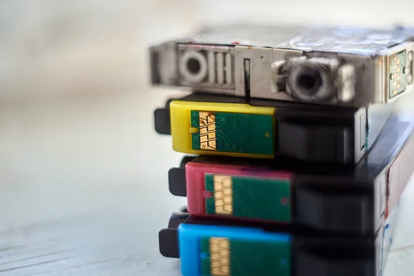 Four used printer cartridges close up