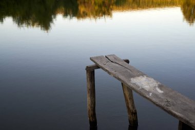Mooring for a boat on the pond in the evening