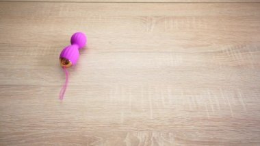 vibrating pink dildo egg on a wooden table