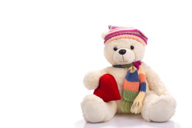 Toy teddy bear sitting with valentine heart clipart