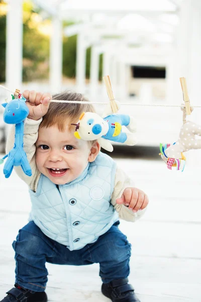 Cute little boy in blue with toys — Stock Photo, Image