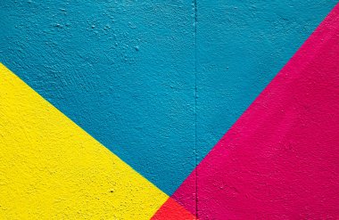 Colorful (yellow, blue pink) brick wall as background, texture