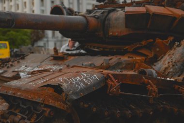 Burnt Russian tank with inscriptions of the names of the destroyed cities in Ukraine