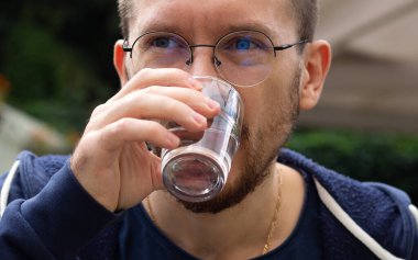 Genç adam su içiyor. sağlık hizmetleri