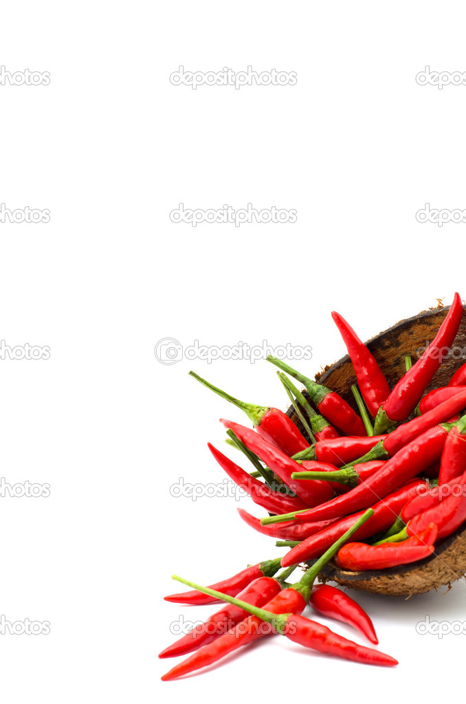 Chillies in a coconut shell isolated on white background