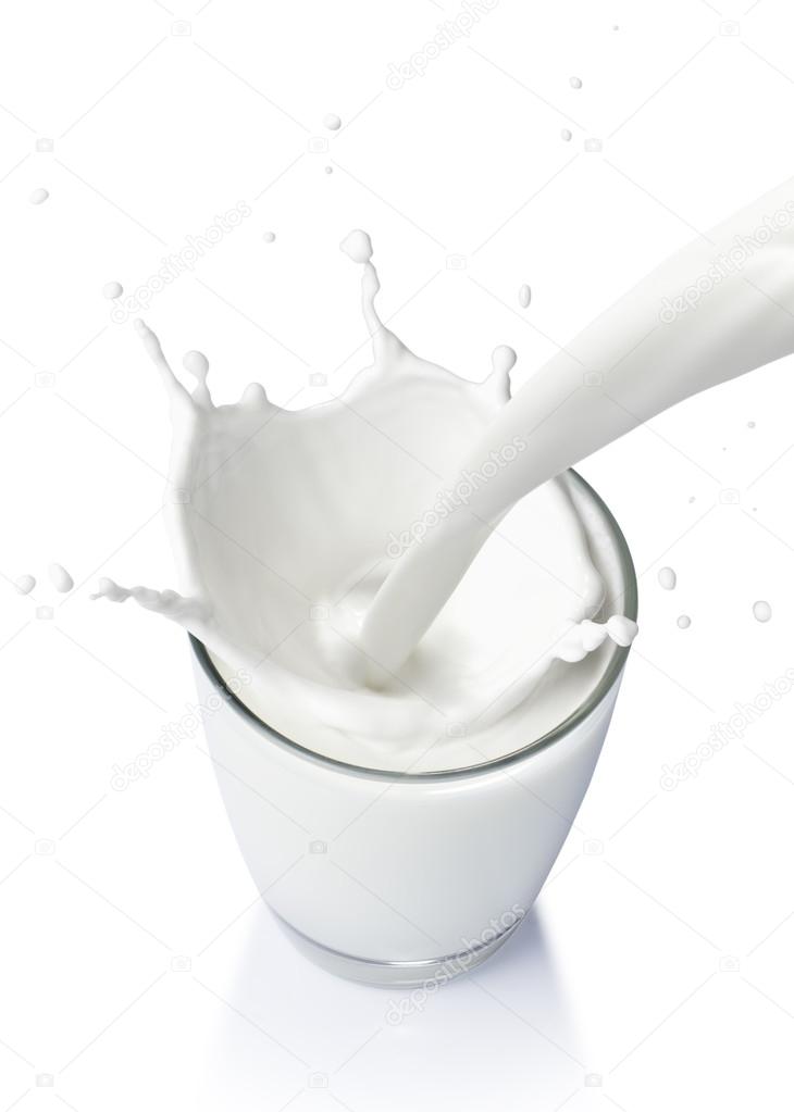 Pouring a glass of milk creating splash isolate on white background