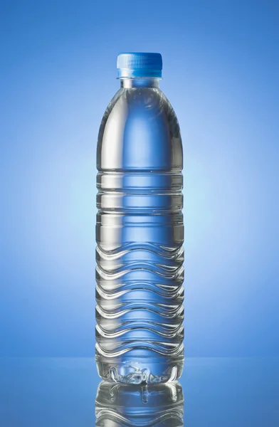 Pet Bottle of water isolated in blue background — Stock Photo, Image