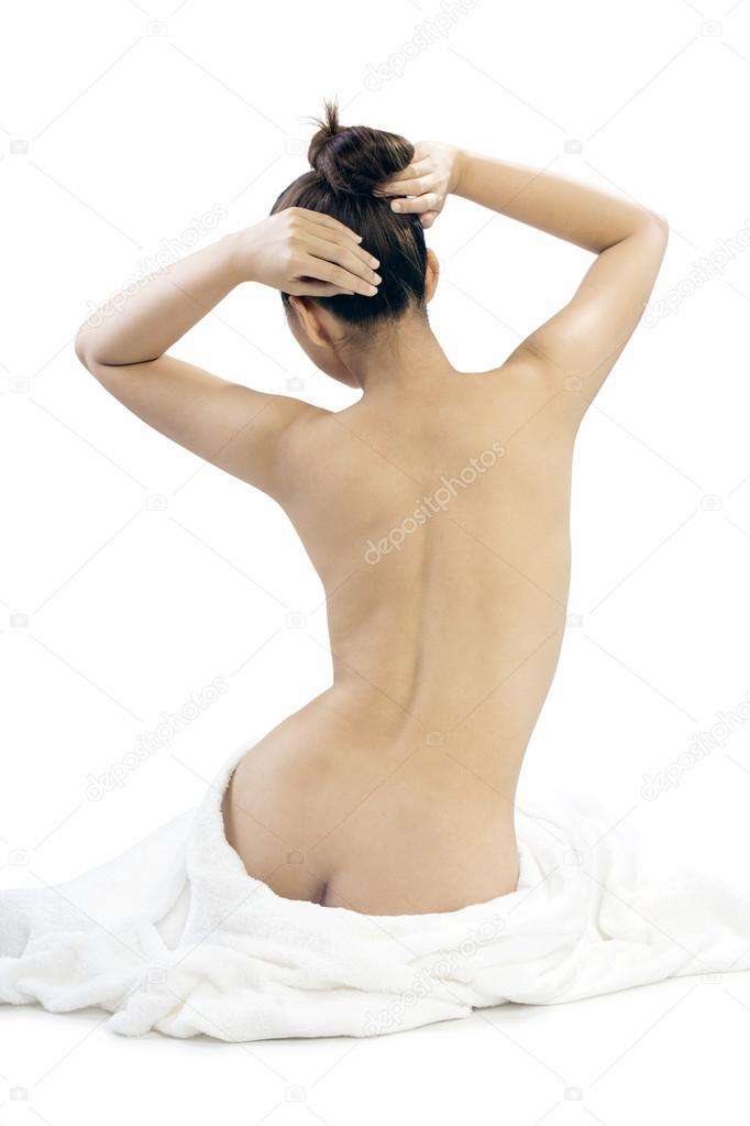Back view of Woman wearing towel sitting on the floor isolated on white background,