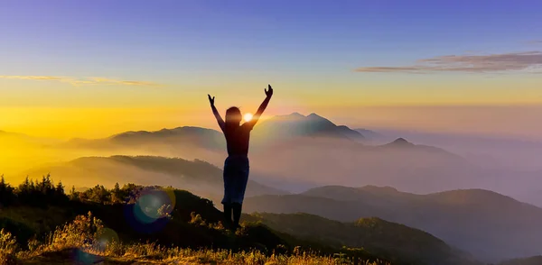 Silhouette of woman climb a peak of mountain hill at sunrise. Girl silhouette raise hand when trek on top mountain at sunset show startup, fight to goal, change to success, leader, challenge concept.