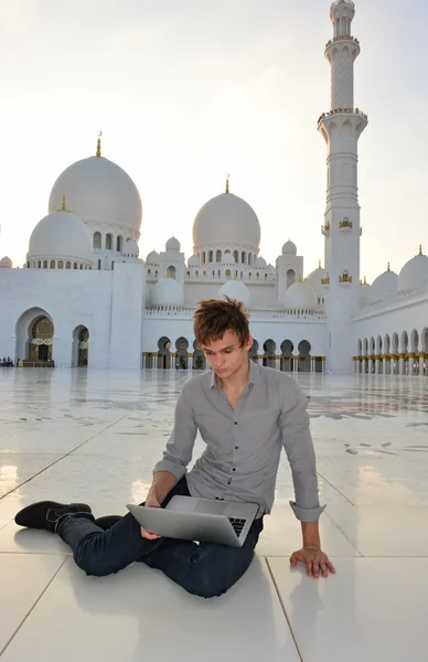 Junger Mann mit Laptop in der Moschee — Stockfoto