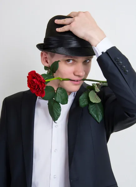 A young man with a rose — Stock Photo, Image