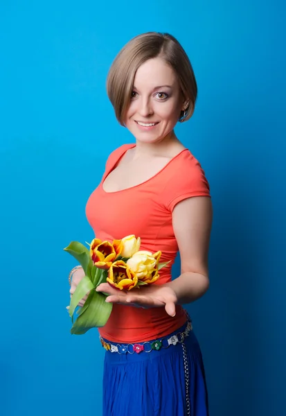 Jeune femme avec un bouquet de tulipes — Photo