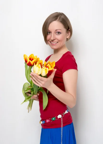 Young woman with a bouquet of tulips — Stock Photo, Image