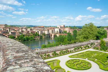 Beautiful view of the Tarn River and a garden with flowers in the Toulouse-Lautrec museum in Albi in France. clipart