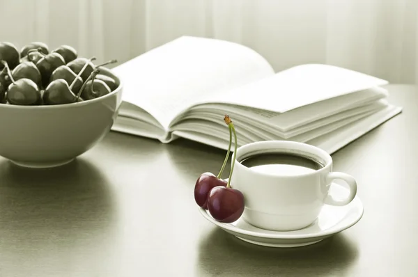 Sweet cherries, cup of coffee and book — Stock Photo, Image