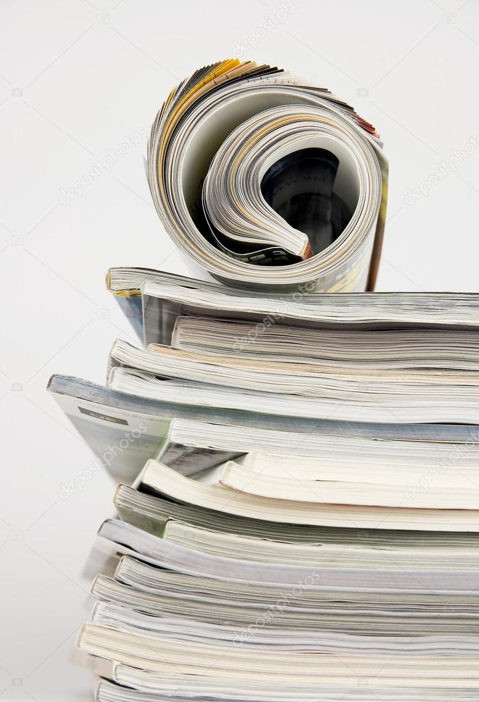 Magazines over white background