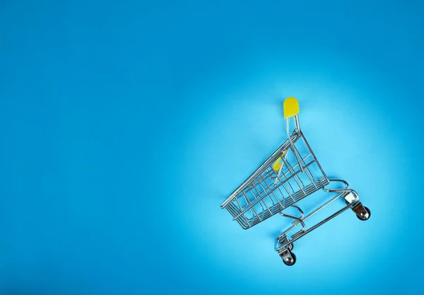 Empty Inverted Shopping Cart Blue Background Inverted Toy Trolley Bright — Stock Photo, Image