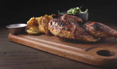 Peru yemeği, Pollo a la brasa veya kızarmış sarı patatesli yarım tavuk ve roka salatası, ahşap tahta. Seçici odak