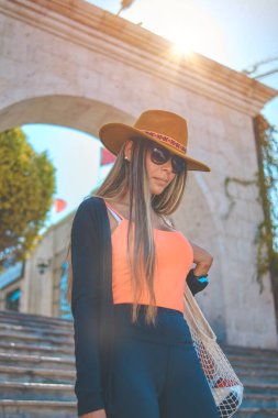 Beautiful smiling woman enjoying on vacation in Yamahuara viewpoint, Arequipa, Peru. Selective Focus.