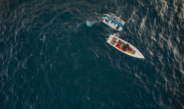 Aerial view of traditional fishing boat in Caraballeda with crystal clear turquoise sea, La Guaira. Venezuela.
