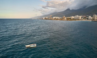 Aerial view of traditional fishing boat in Caraballeda with crystal clear turquoise sea, La Guaira. Venezuela.