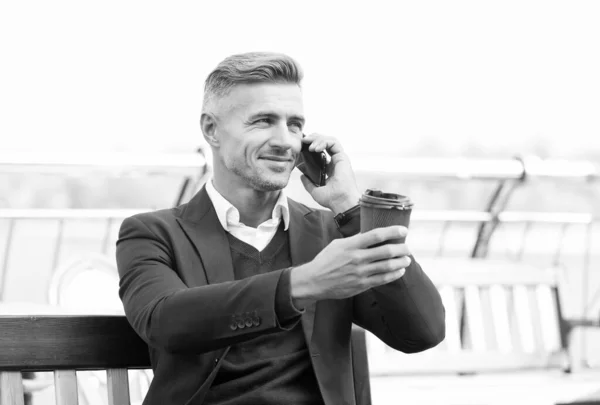 Happy manager behandelen afhaalkopje koffie praten op mobiele telefoon buiten, genieten — Stockfoto