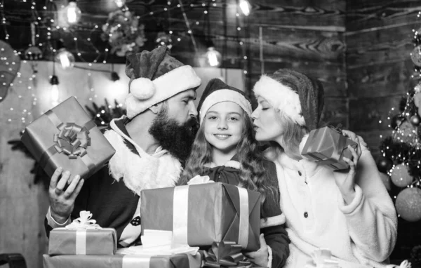 Prezent świąteczny. Wesołych Świąt. Ojciec i matka kochają córkę. Zimowe wakacje. Wiele pudełek prezentuje Boże Narodzenie. Szczęśliwa rodzina świętuje Nowy Rok. małe dziecko i rodzice w santa kapeluszu — Zdjęcie stockowe